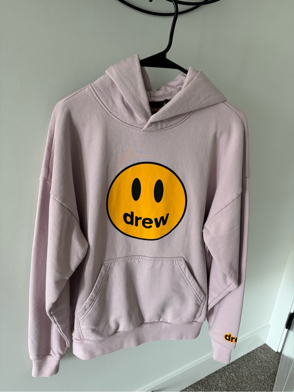 drew house light pink hoodie with yellow smiley logo
